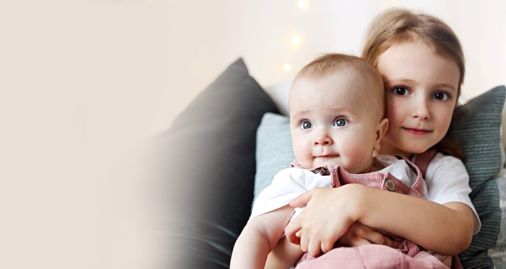 A big sister holding the baby