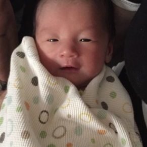 A newborn girl in a pink bow